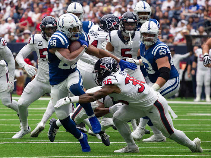 Sep 11, 2022; Houston, Texas, USA; Indianapolis Colts running back Jonathan Taylor (28) rushes against Houston Texans safety Jonathan Owens (36) in the first quarter at NRG Stadium. Mandatory Credit: Thomas Shea-USA TODAY Sports